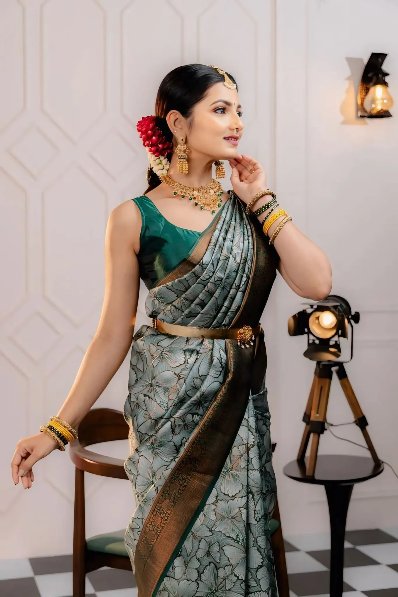 THE SAREE SHOWCASES A DELICATE INTERPLAY OF COLORS AND PATTERNS